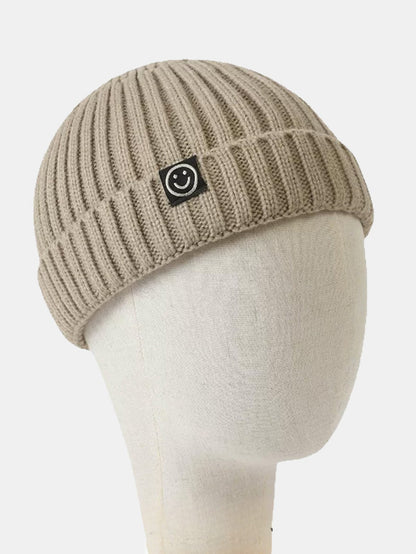Gorro docker curto de tricô canelado com punho dobrado e etiqueta tecida de carinha sorridente