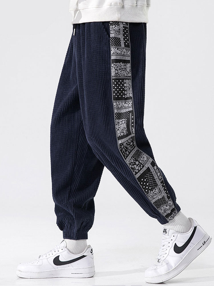 Calça de veludo cotelê com painéis estampados de paisley