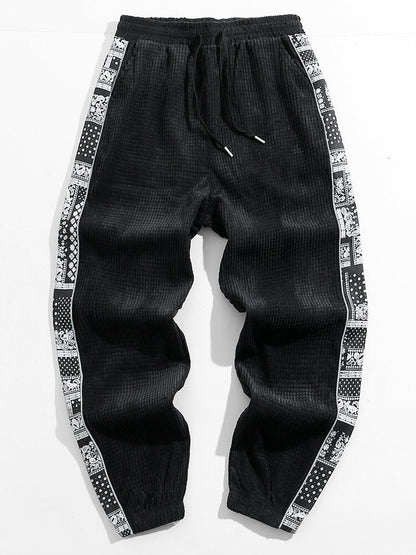 Calça de veludo cotelê com painéis estampados de paisley