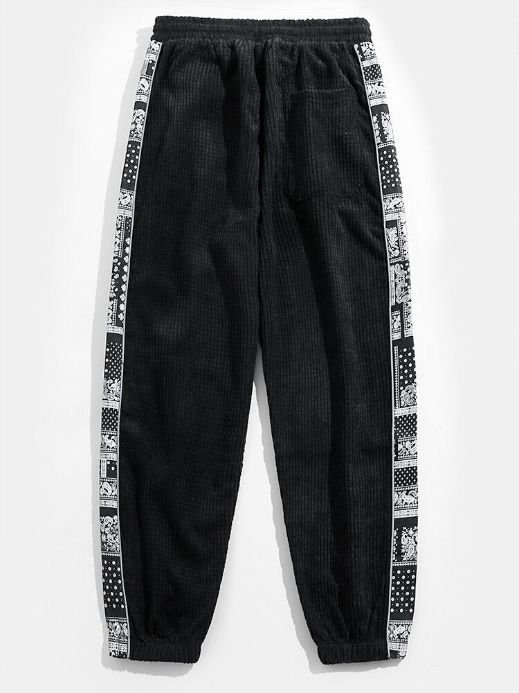 Calça de veludo cotelê com painéis estampados de paisley